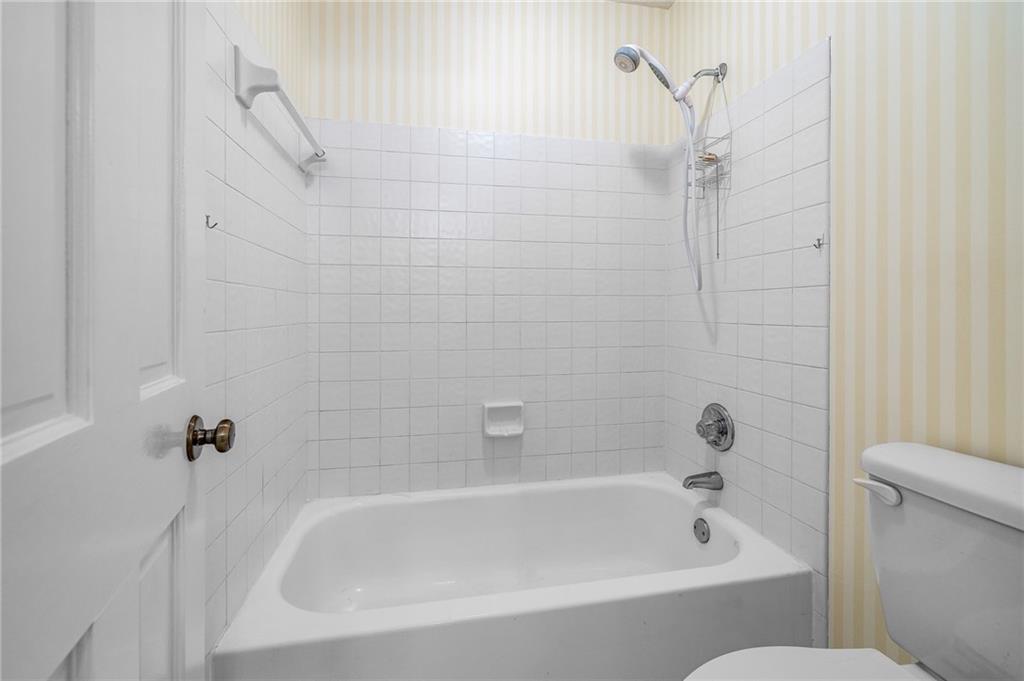 3374 Floral Court Suwanee, GA 30024 - Photo 28 of 54 a white bath tub sitting next to a white toilet and sink