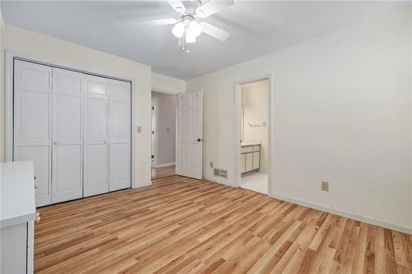 an empty room with chandelier fan
