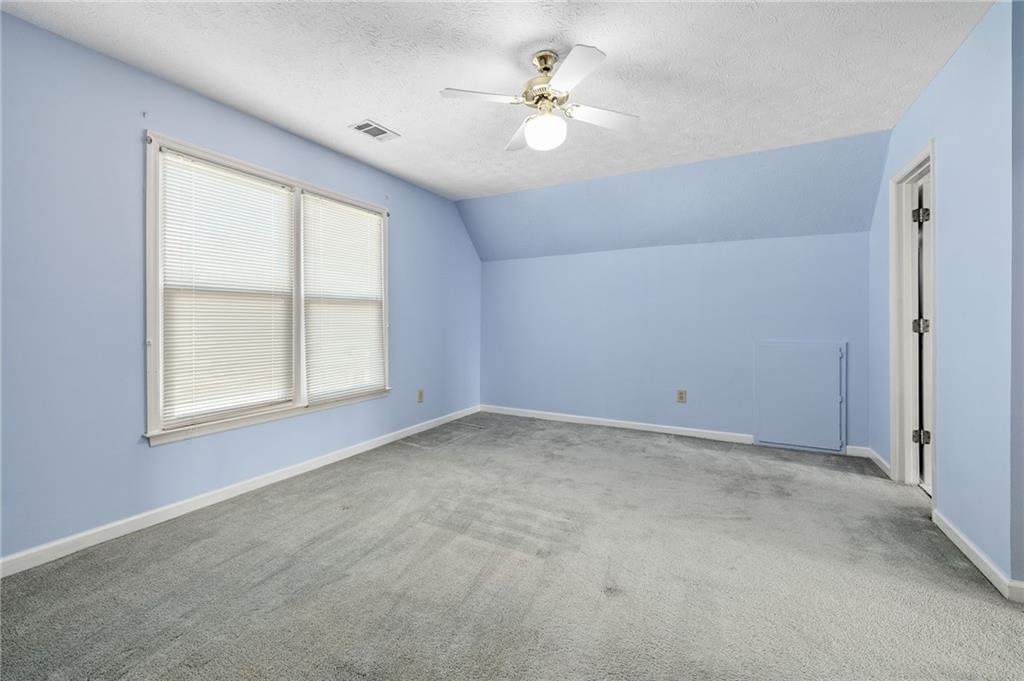 3374 Floral Court Suwanee, GA 30024 - Photo 31 of 54 an empty room with windows and ceiling fan