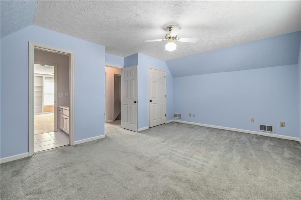 3374 Floral Court Suwanee, GA 30024 - Photo 32 of 54 an empty room with chandelier fan