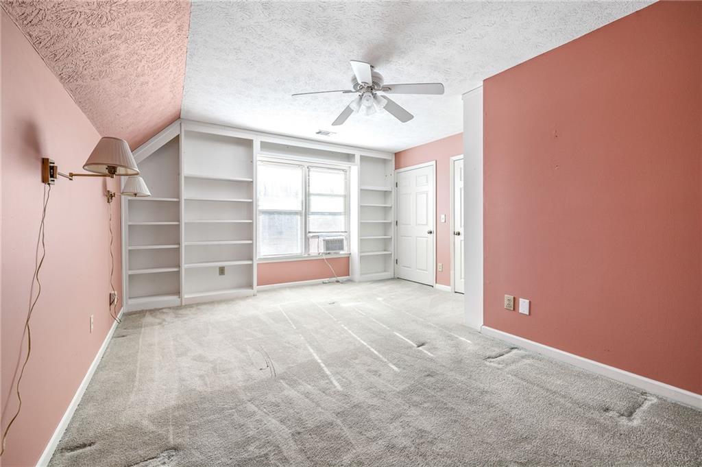 3374 Floral Court Suwanee, GA 30024 - Photo 33 of 54 an empty room with a ceiling fan and window