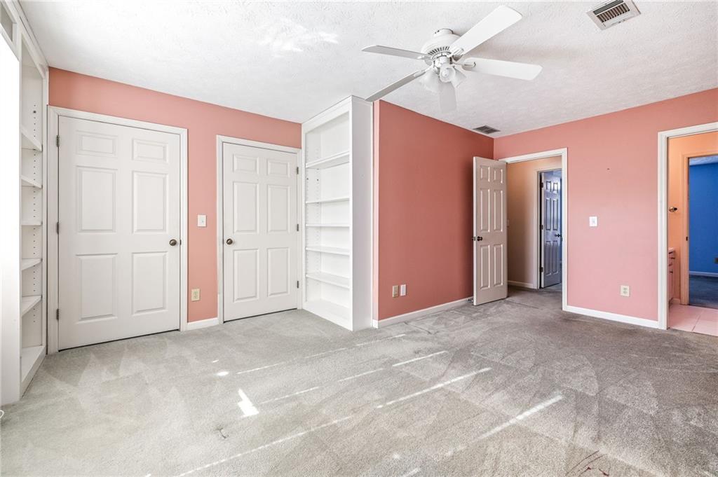 3374 Floral Court Suwanee, GA 30024 - Photo 34 of 54 an empty room with closet and a ceiling fan