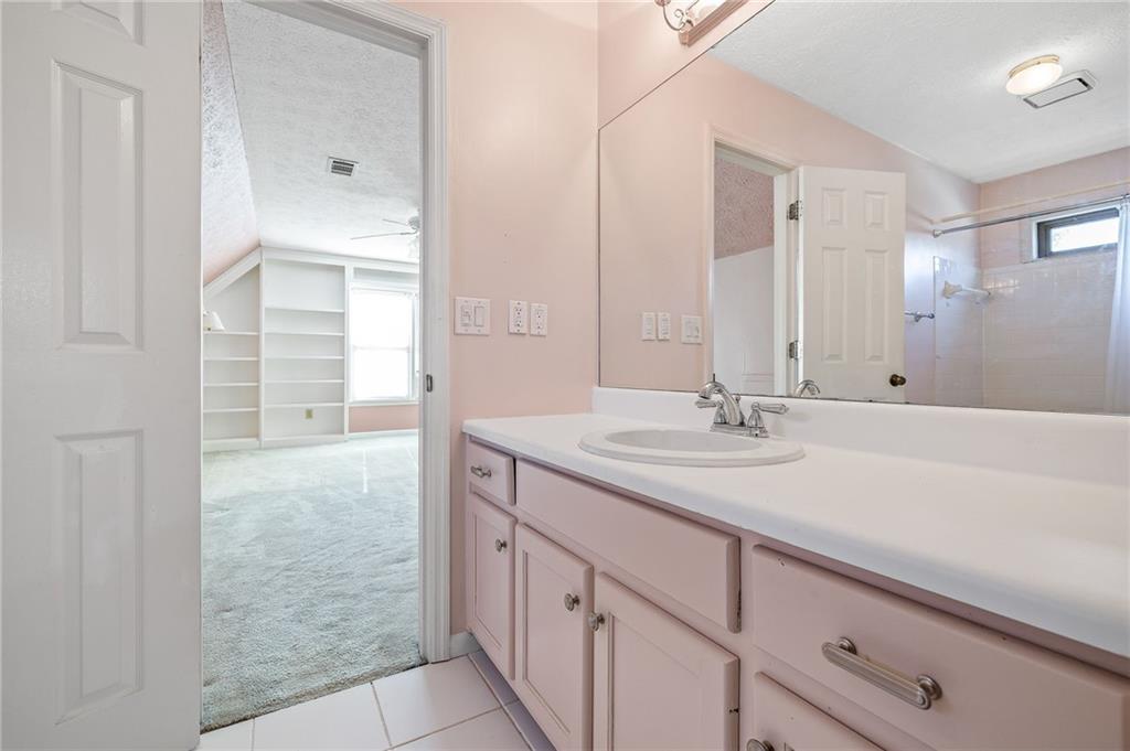 3374 Floral Court Suwanee, GA 30024 - Photo 35 of 54 a bathroom with a sink and a mirror with bathtub