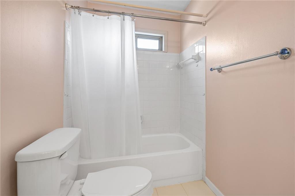 3374 Floral Court Suwanee, GA 30024 - Photo 36 of 54 a white toilet sitting next to a bath tub