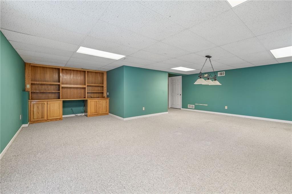 3374 Floral Court Suwanee, GA 30024 - Photo 38 of 54 a view of empty room with a fireplace and cabinet