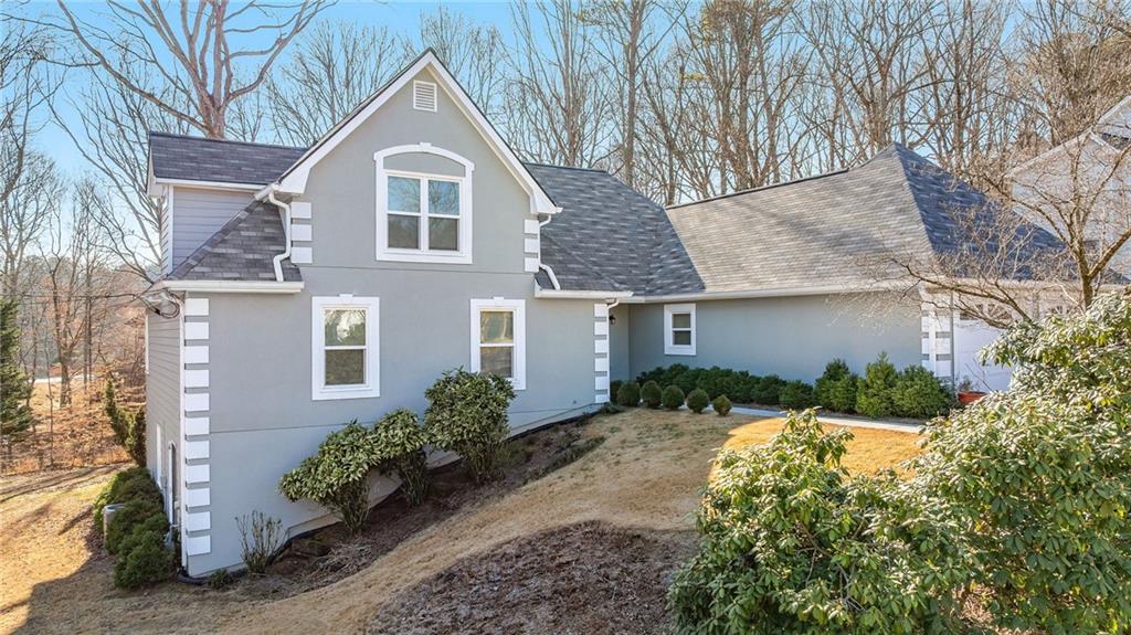 3374 Floral Court Suwanee, GA 30024 - Photo 4 of 54 a front view of a house with a yard and garage
