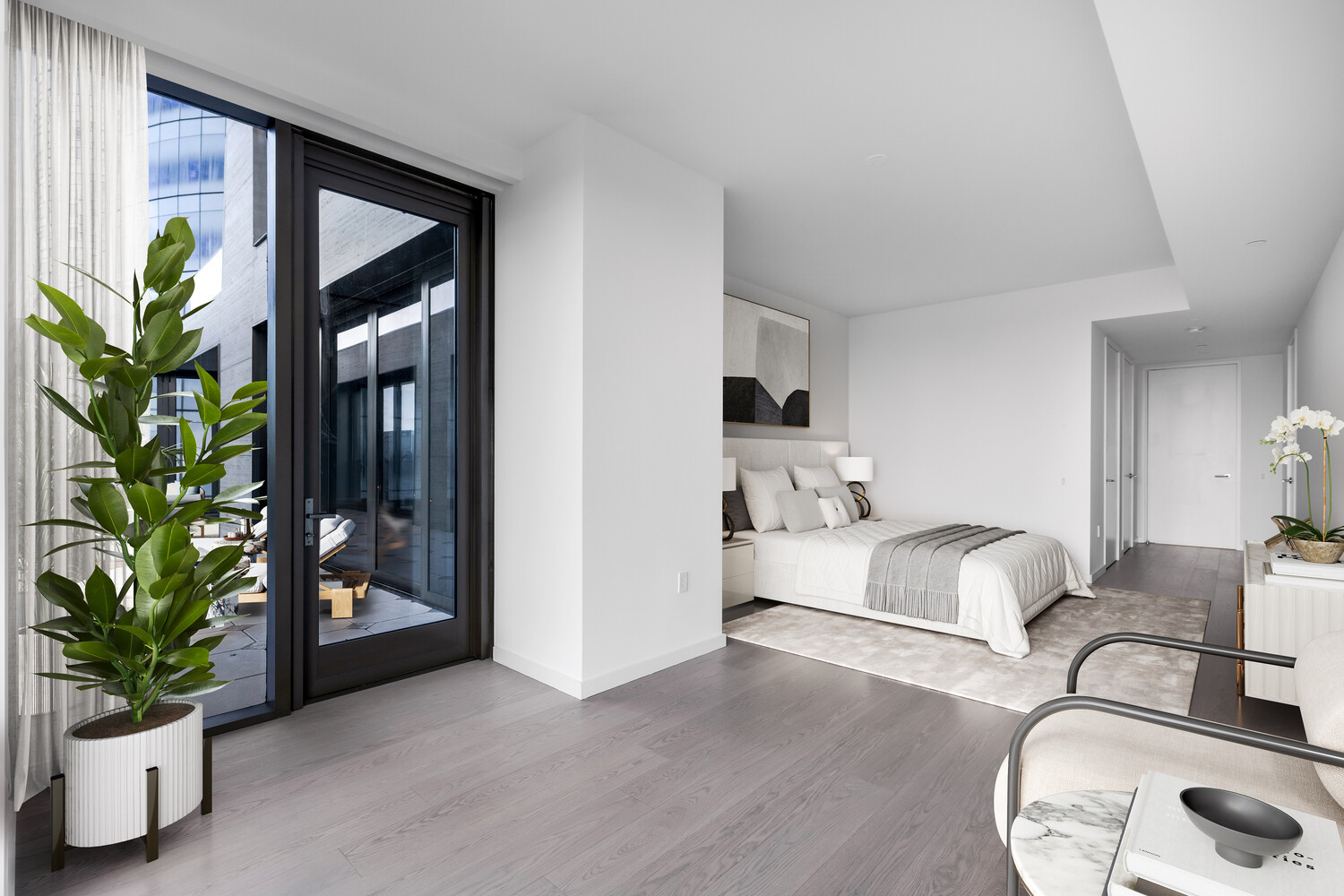 500 West 18th Street, Unit 5C Manhattan, NY 10011 - Photo 5 of 9 a bed room with furniture and a potted plant