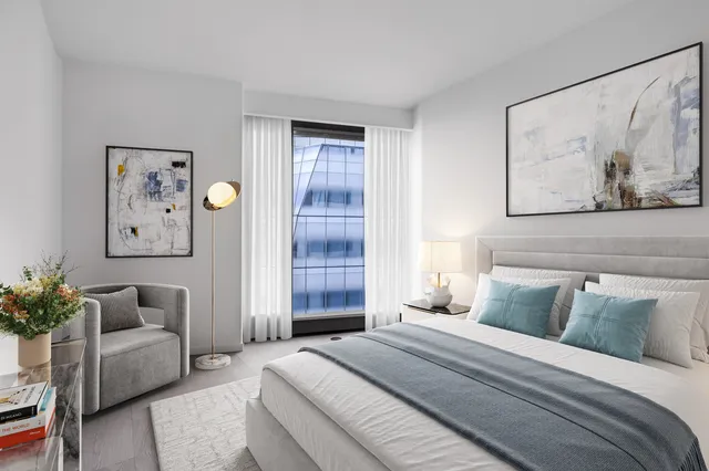 a bedroom with furniture and a potted plant