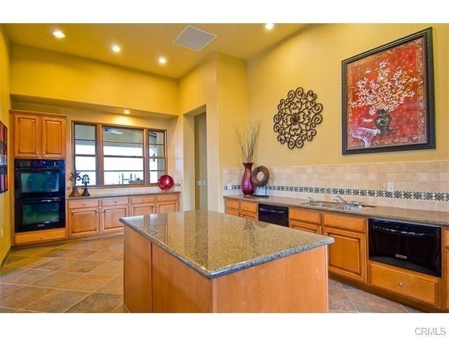 30240 Lamplighter Lane Menifee, CA 92584 - Photo 19 of 20 a kitchen with a sink cabinets and wooden floor