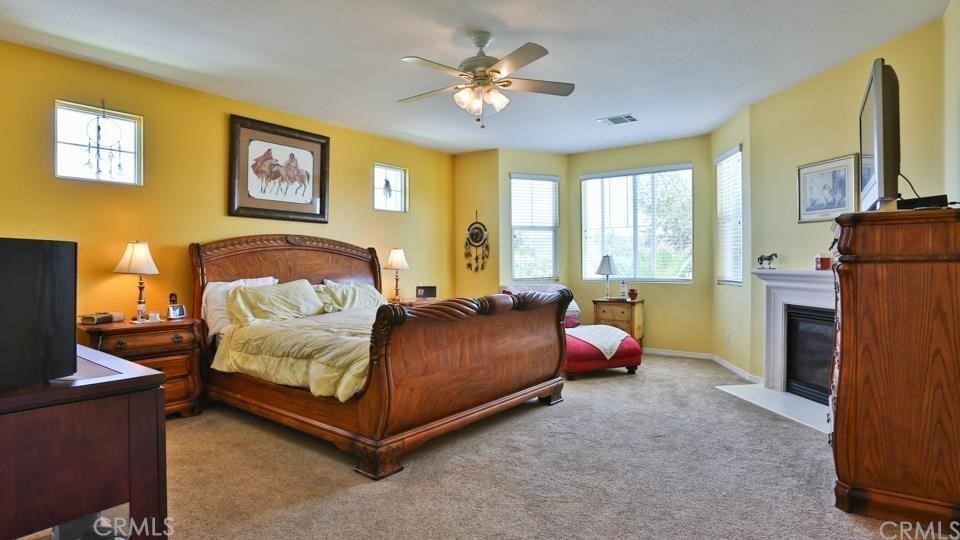 30240 Lamplighter Lane Menifee, CA 92584 - Photo 10 of 20 a bedroom with a bed and a chandelier
