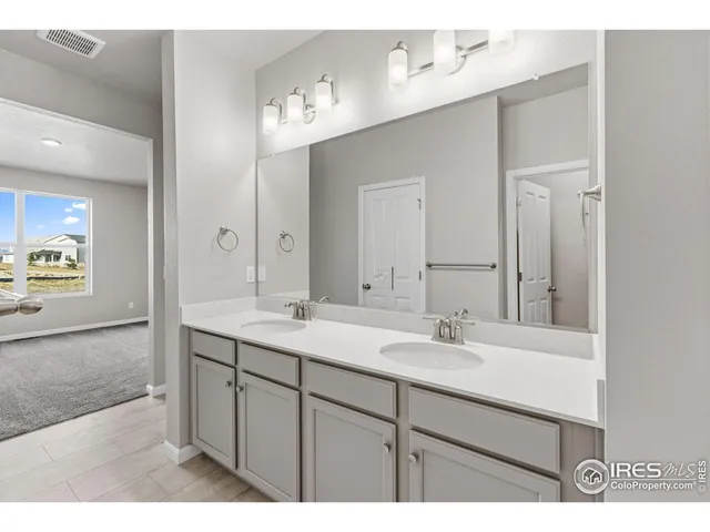 a bathroom with a sink double vanity and a mirror