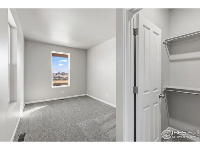 a view of an empty room and a window