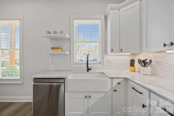 a kitchen with a sink cabinets and window