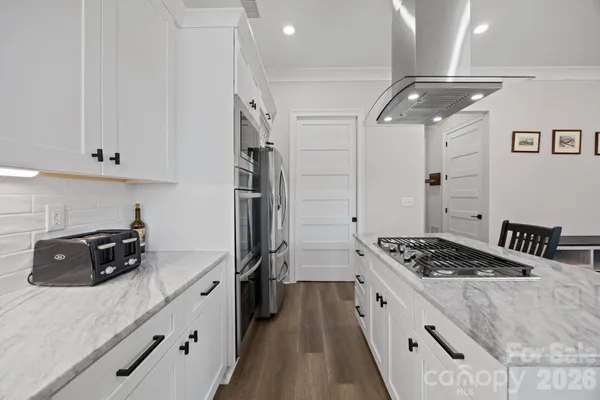 a kitchen with refrigerator and stove
