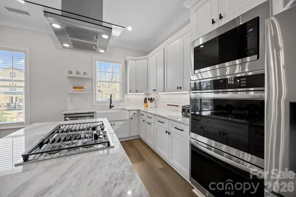 a kitchen with a stove a sink and a microwave