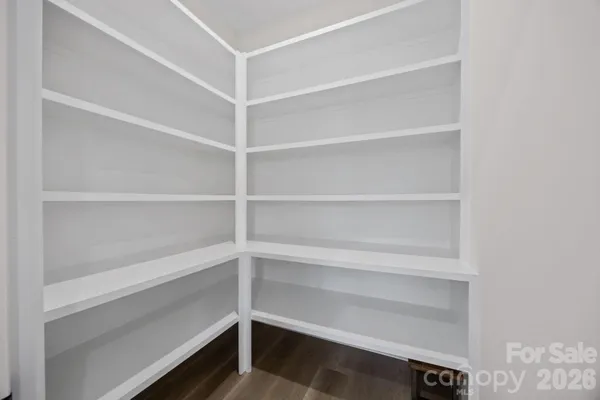 a view of walk in closet with empty racks