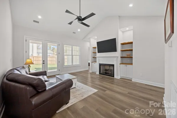 a living room with furniture a fireplace and a flat screen tv