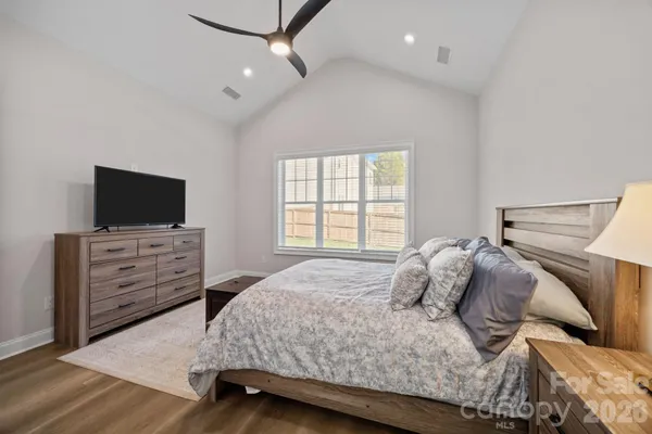 a bedroom with a bed and flat screen tv