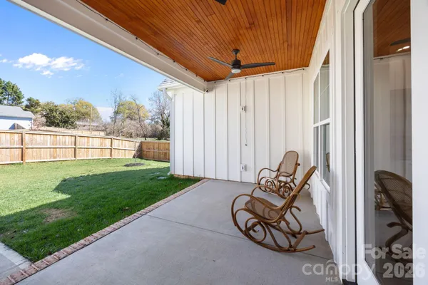a view of a backyard with sitting area and furniture