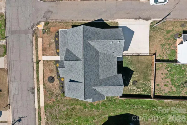 an aerial view of multiple houses with a yard