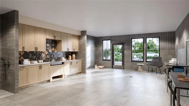 a large white kitchen with lots of counter top space and wooden floor
