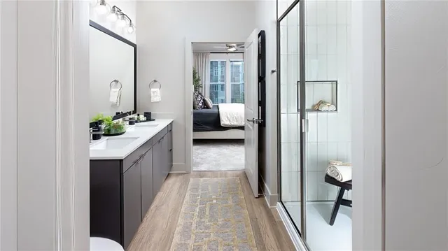 a en suite bathroom with a granite countertop sink and a mirror