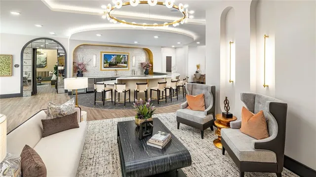 a living room with furniture and a large mirror