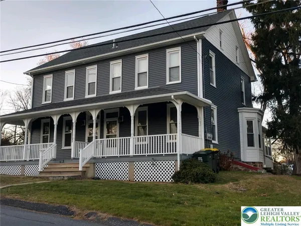a front view of a house with a garden