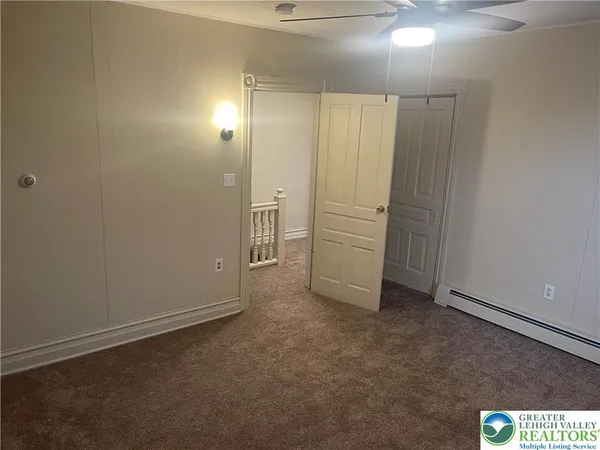 an empty room with closet and bathroom
