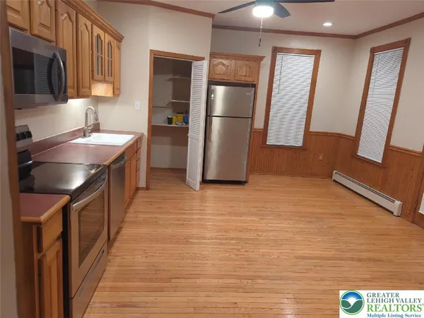 a kitchen with stainless steel appliances granite countertop a refrigerator a sink and a stove