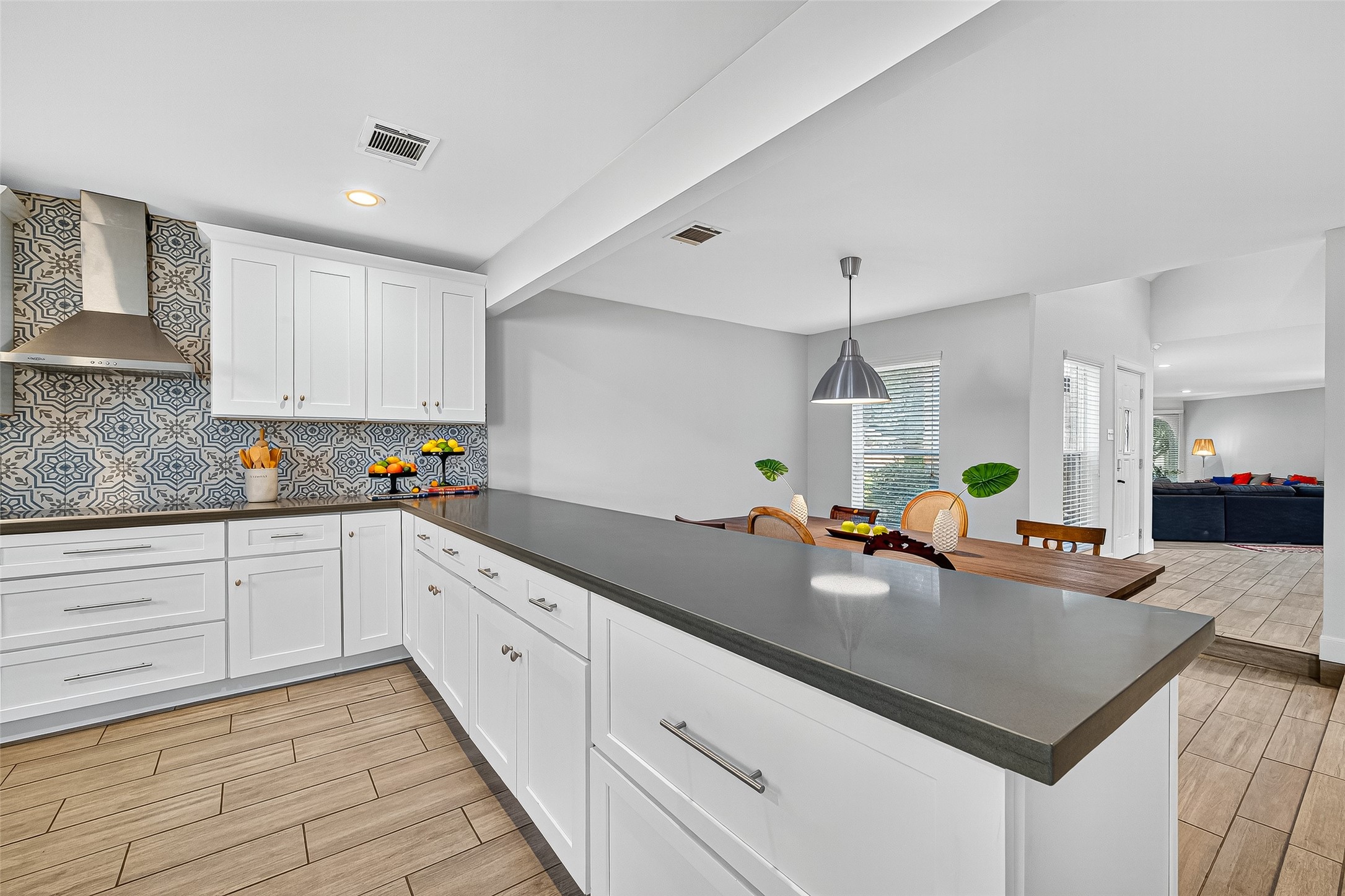 818 Silvergate Drive Houston, TX 77079 - Photo 12 of 40 a kitchen with a sink dishwasher and white cabinets with wooden floor