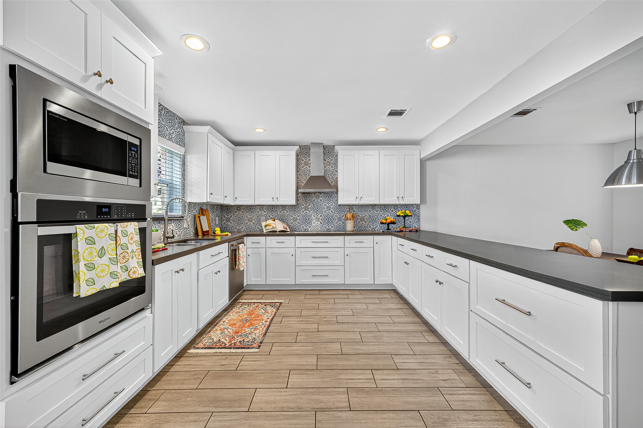 818 Silvergate Drive Houston, TX 77079 - Photo 13 of 40 a large kitchen with stainless steel appliances granite countertop a stove a sink and a microwave