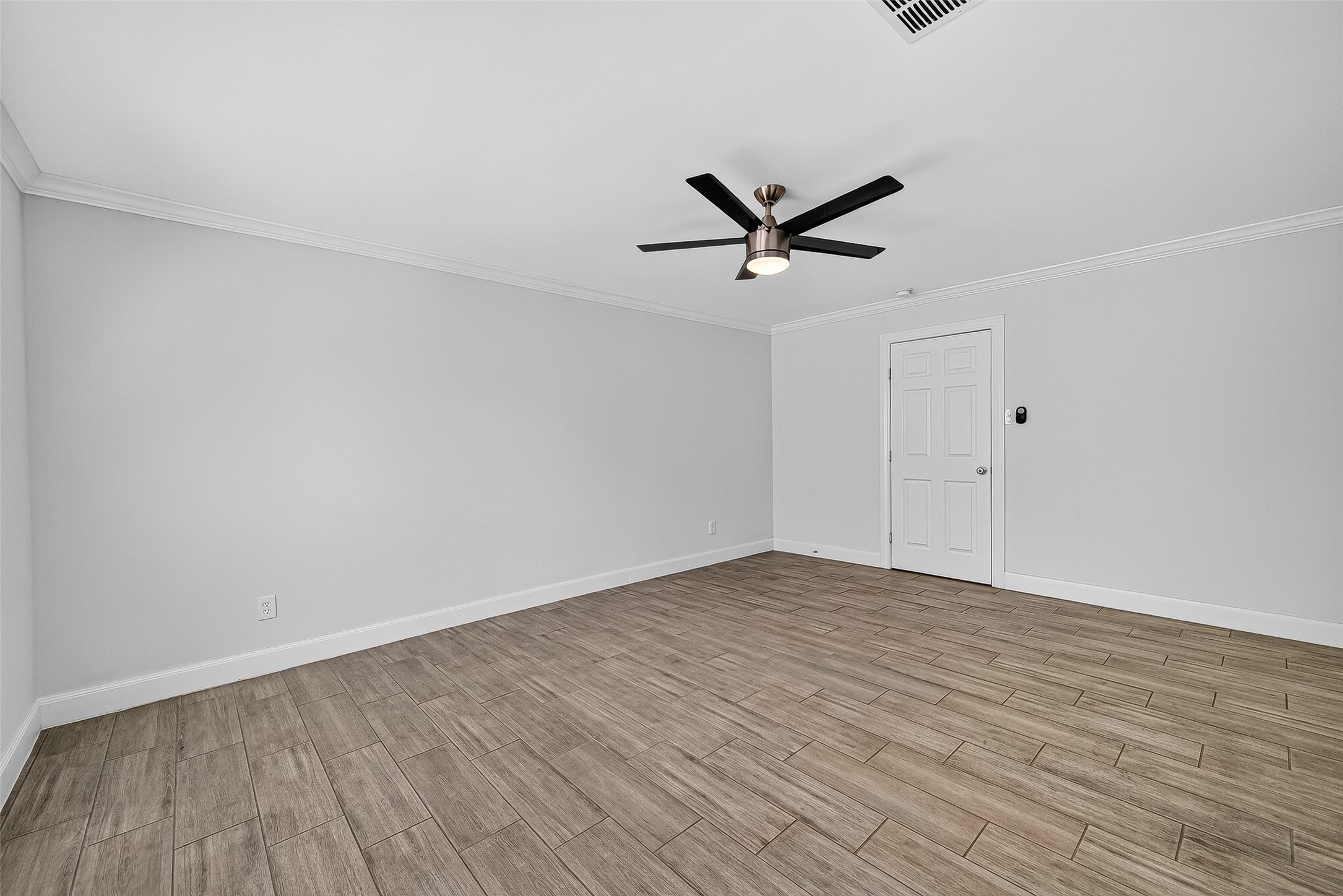 818 Silvergate Drive Houston, TX 77079 - Photo 22 of 40 a view of a big room with wooden floor and a ceiling fan