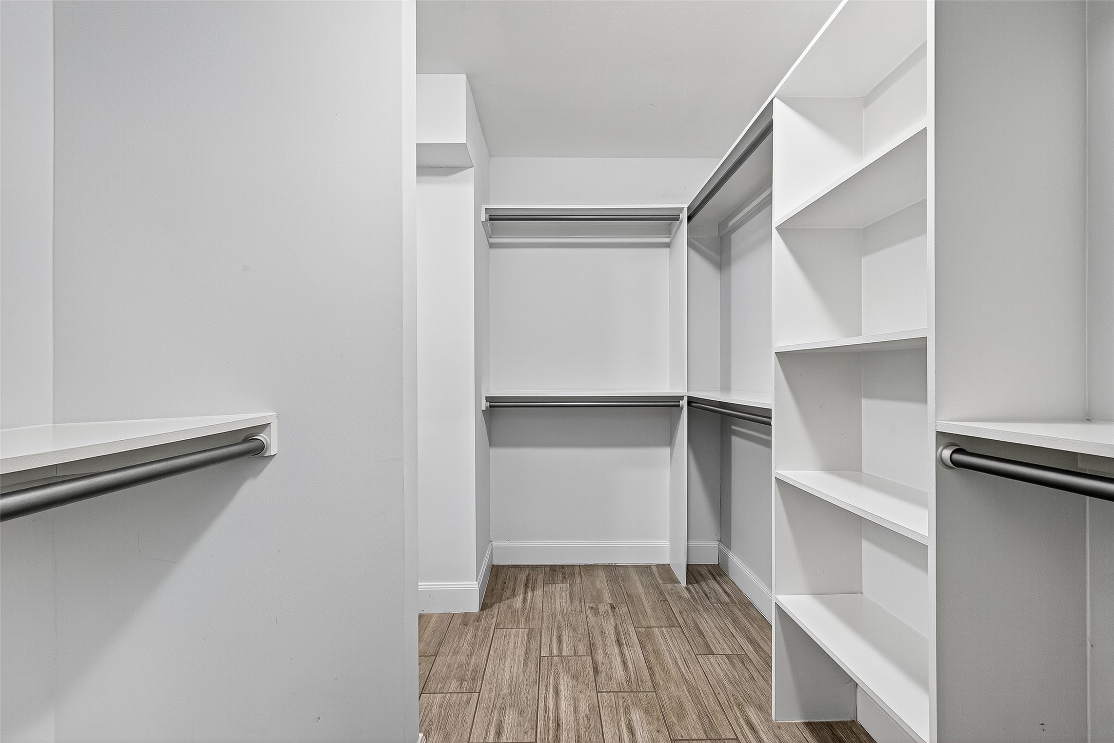 818 Silvergate Drive Houston, TX 77079 - Photo 25 of 40 a view of walk in closet with empty racks