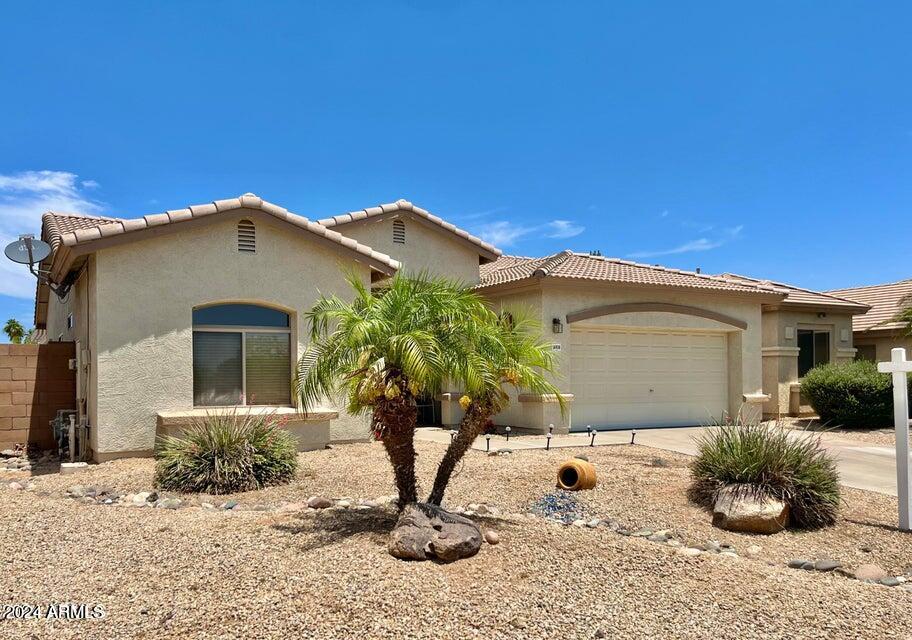 16908 West Northampton Road Surprise, AZ 85374 - Photo 7 of 13 a front view of a house with a yard
