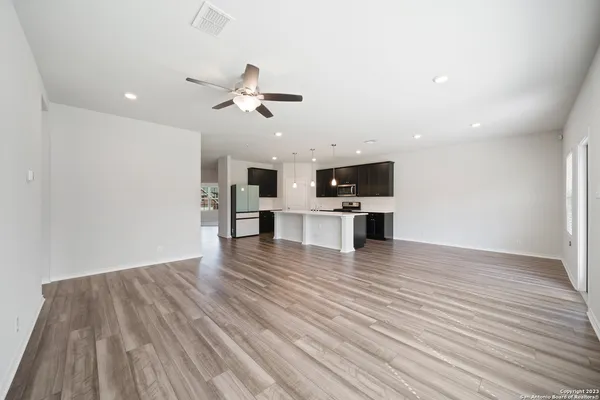 a view of kitchen with microwave and wooden floor