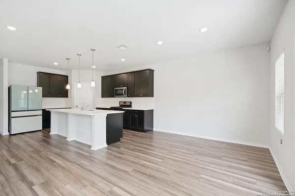a view of kitchen with microwave oven stove and oven
