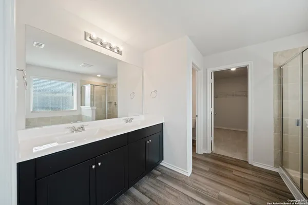 a bathroom with a double vanity sink and mirror