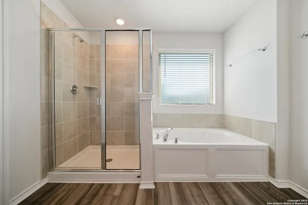 a bathroom with a bathtub and a shower