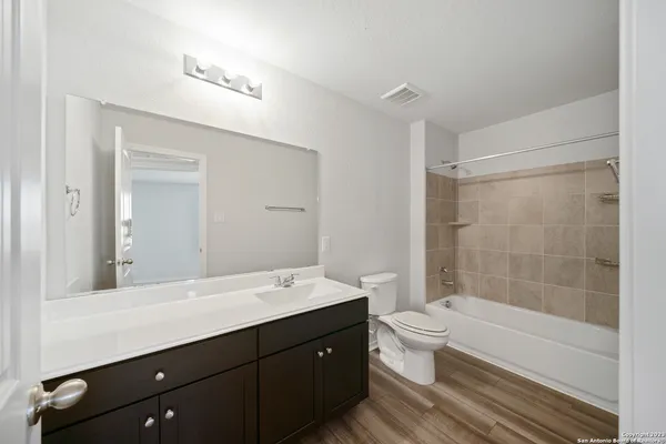 a bathroom with a double vanity sink toilet and shower