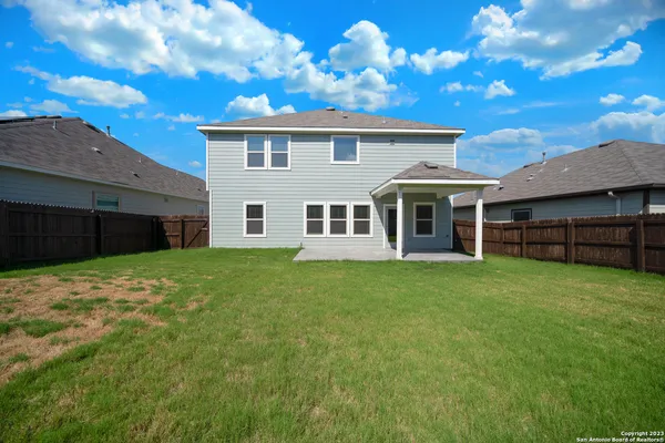 a view of a house with a backyard