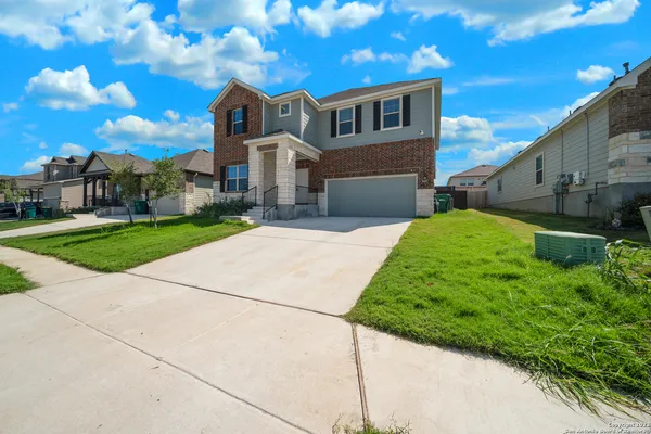 a front view of a house with a yard