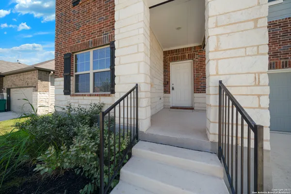 a view of staircase with railing and white walls