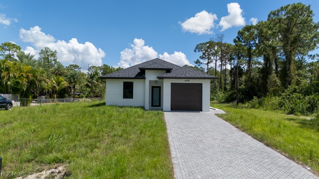 2006 Truman Avenue Alva, FL 33920 - Photo 2 of 45 a front view of a house with yard and green space
