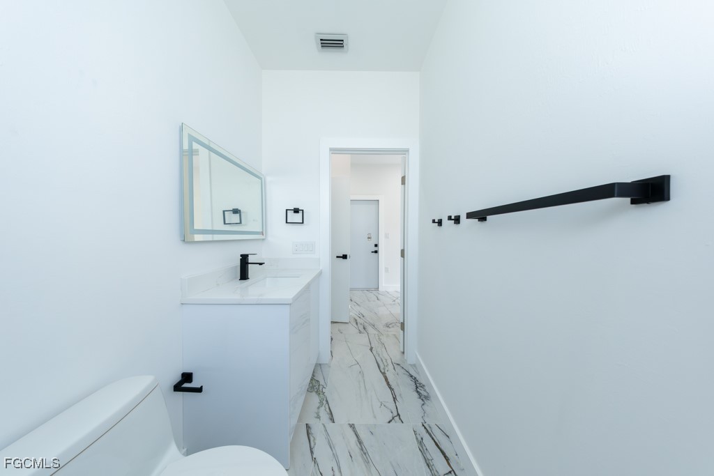 2006 Truman Avenue Alva, FL 33920 - Photo 29 of 45 a bathroom with a sink a toilet a shower and a mirror