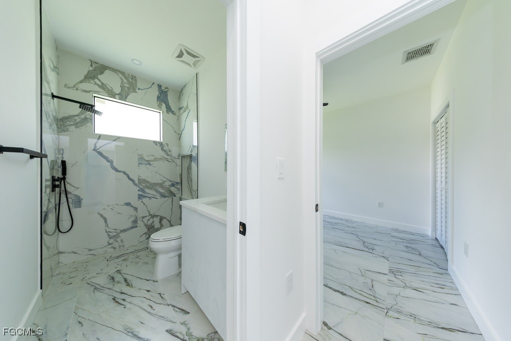 2006 Truman Avenue Alva, FL 33920 - Photo 33 of 45 a bathroom with a granite countertop shower and a toilet