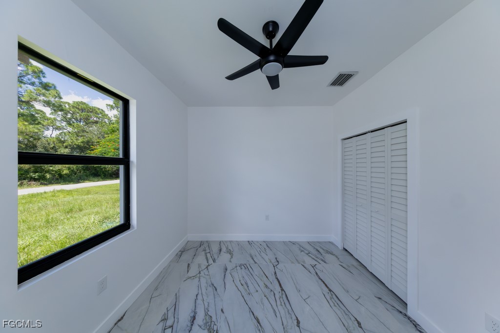 2006 Truman Avenue Alva, FL 33920 - Photo 39 of 45 an empty room with wooden floor fan and windows
