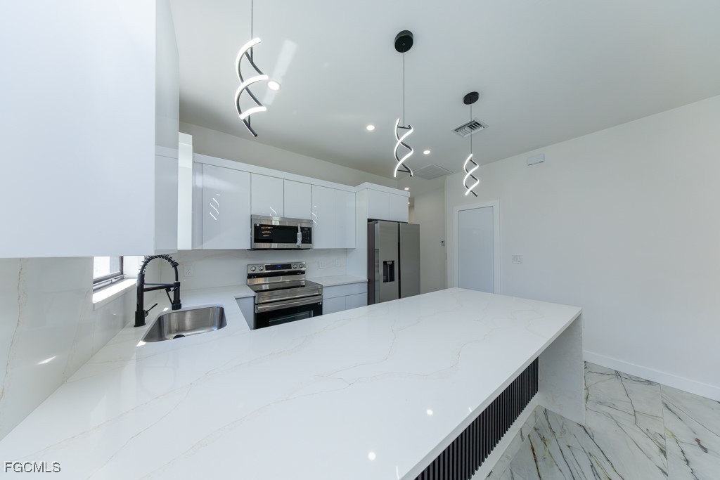 2006 Truman Avenue Alva, FL 33920 - Photo 7 of 45 a kitchen with stainless steel appliances a refrigerator sink and stove