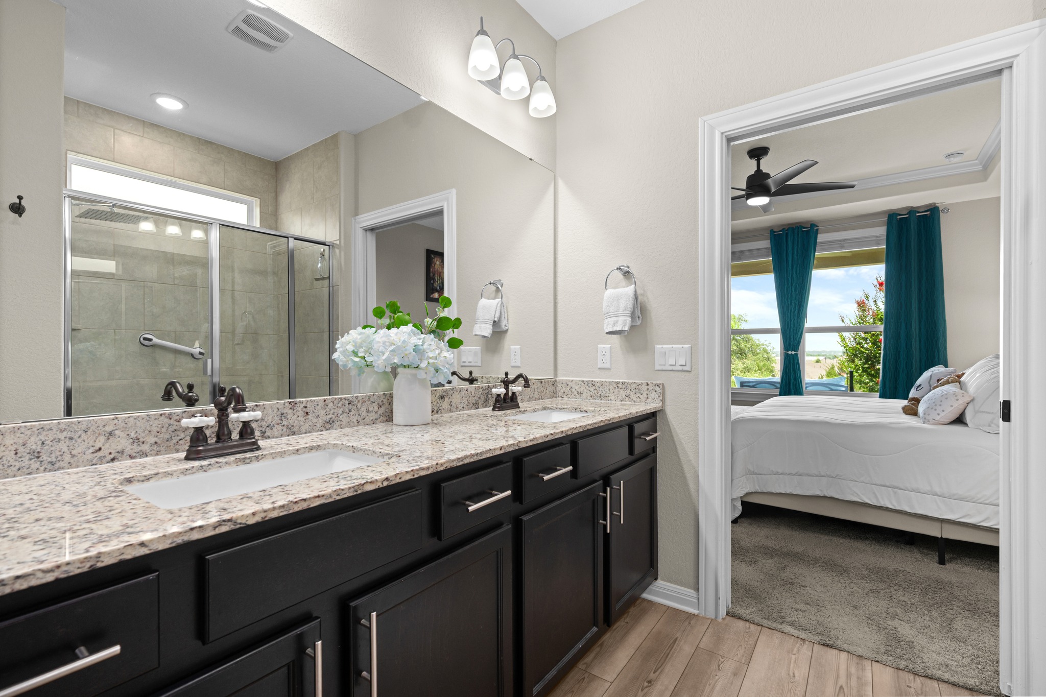 202 Yorktown Street Georgetown, TX 78633 - Photo 13 of 35 Double vanity with granite counters and a spacious walk-in shower elevate this contemporary bathroom.