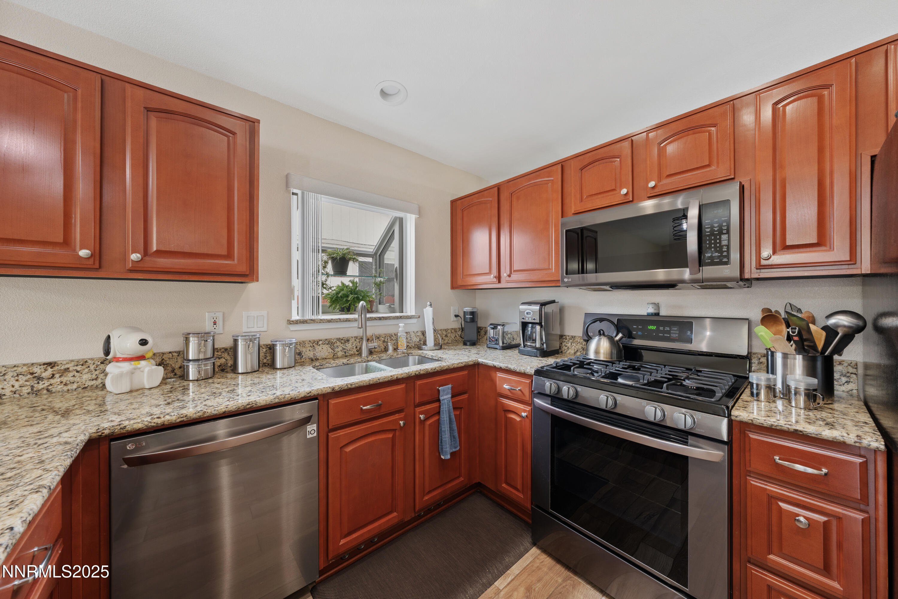 17785 Fortune Court Reno, NV 89508 - Photo 11 of 43 a kitchen with stainless steel appliances granite countertop a stove sink microwave and cabinets